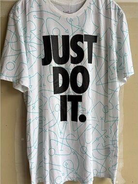 Nike White Tee with Black 'JUST DO IT.' and Teal Graphic Lines